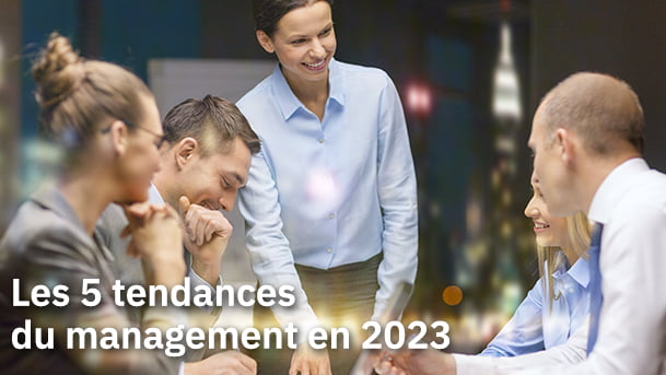 Article sur "les 5 tendances du management en 2023" imagé par une photo d'un groupe de travail avec une femme debout devant 4 collaborateurs, deux hommes et deux femmes.
